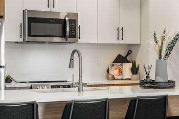a kitchen with a sink and a microwave
